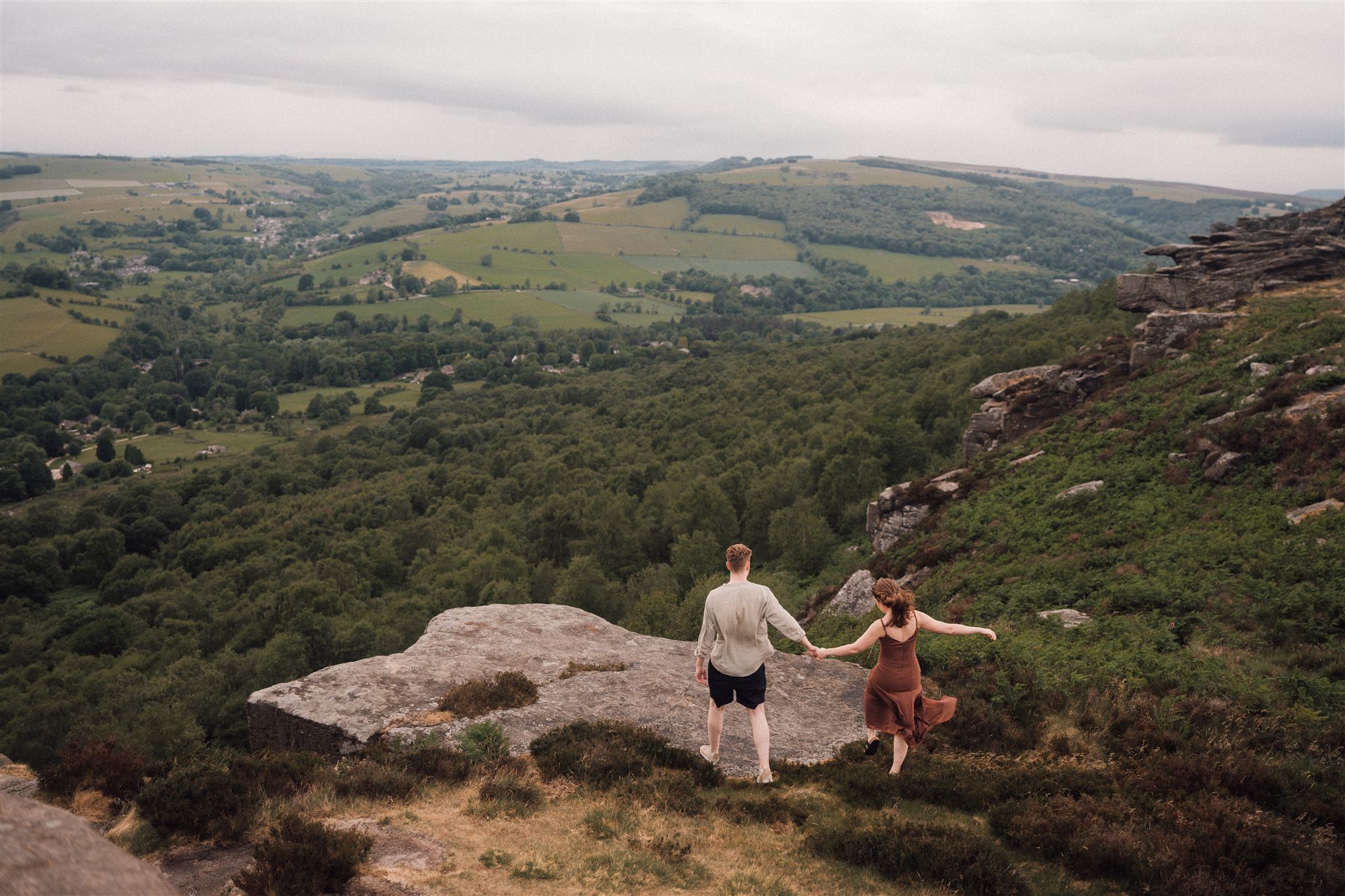 Couple at Curbar Edge with Derwent Valley behind, Peak District engagement photography - Bowl of Corks