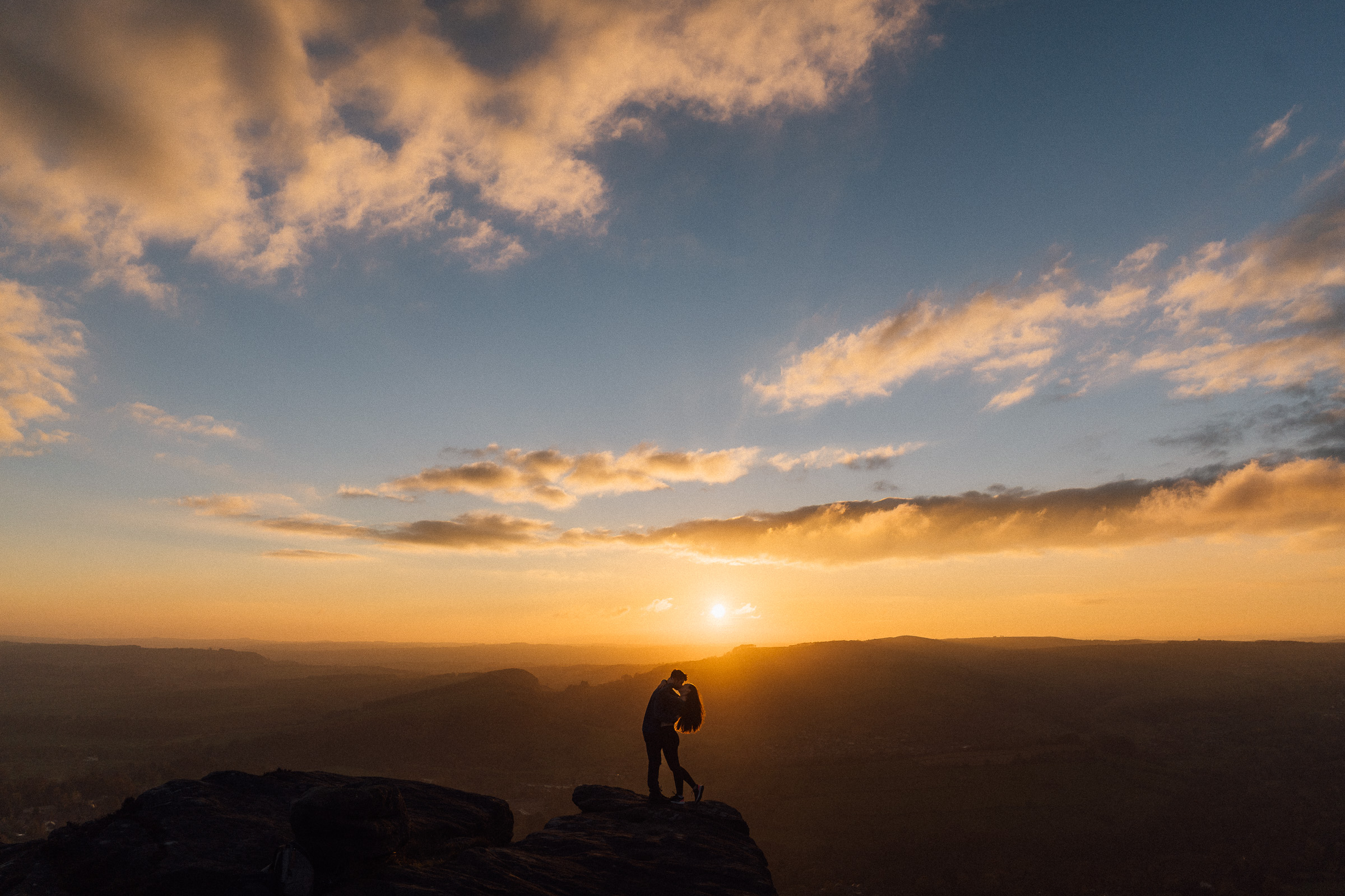 Couple at Stanage Edge, Peak District engagement photography - Bowl of Corks